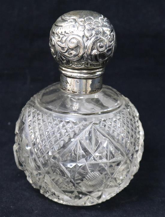 An Edwardian silver topped cut glass scent bottle, 12.5cm.